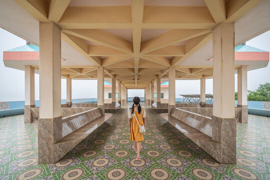 The young girl walking on the view point building at Wat Khao Pratu Chumphon, Chaiyaphum, Thailand