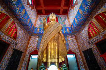 The gold Buddha statue inside the beautiful pagoda at Wat Phra That Ket Kaeo Chulamni, Chaiyaphum, Thailand