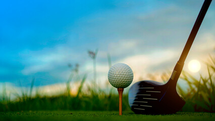 Golf clubs and balls on a green lawn in a beautiful golf course with morning sunshine.