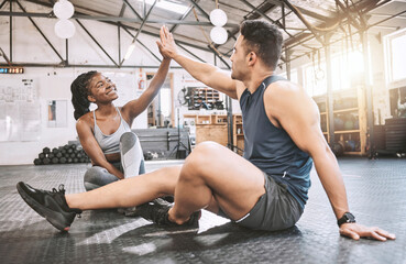 High five, sports and team of athletes in gym with achievement, challenge or training together. Happy, celebration and young man and woman cheering for workout partnership goals in fitness center.