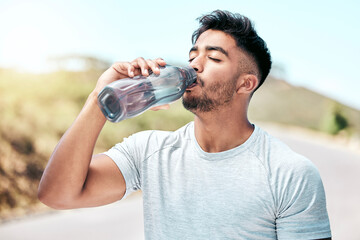 Fitness, man and drinking water in nature for health, wellness an hydration in day. Thirsty, liquid...