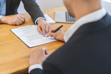 Asian landlord, realtor man pointing on paper for sign signature contract with tenant rental or...