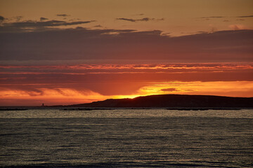 Sunset in red hues over playa america with las estelas in the background