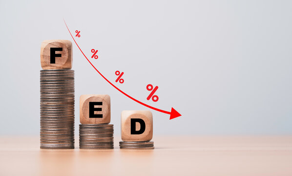 FED wording on the top of coins stacking with coins decreasing  down arrow and percentage  for FED will reduce interest rating concept.