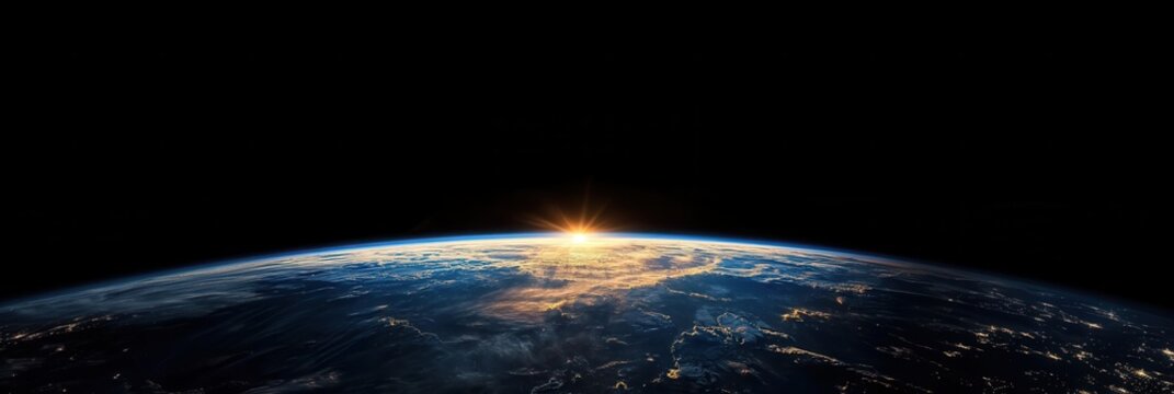 View of Earth with sunlit clouds and the atmosphere against the backdrop of black space above the planet