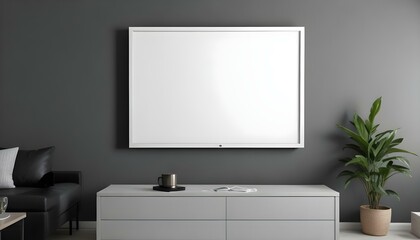 A large white framed canvas or projection screen mounted on a gray wall above a modern gray cabinet or entertainment.