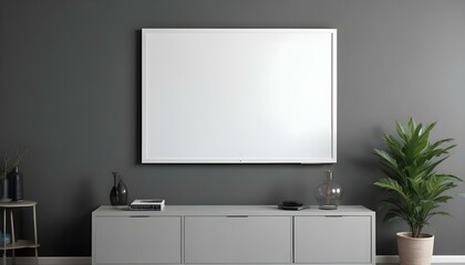 A large white framed canvas or projection screen mounted on a gray wall above a modern gray cabinet or entertainment.