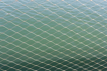 Mesh against the blue sea. Background. Texture.