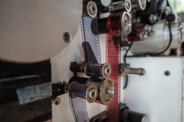 A detailed close-up view of a vintage film projector’s mechanical components, showcasing gears,...