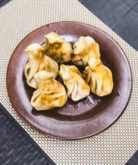 Fried khinkali in a plate on the table