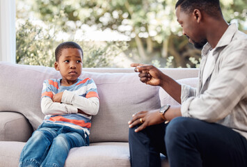 Child, father and upset on sofa for discipline, frustrated and check for bad behavior at home. Dad,...