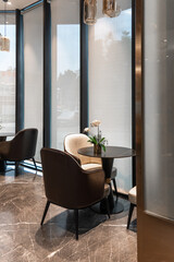 chairs and table near glass wall