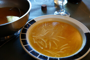 Homemade cocido Soup with pasta on a plate Spain