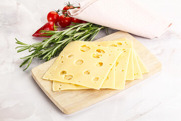 Sliced maasdam cheese with holes