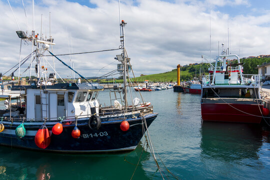 Suances coast Cantabria Spain in July 2024 fishing boats moored at harbour.