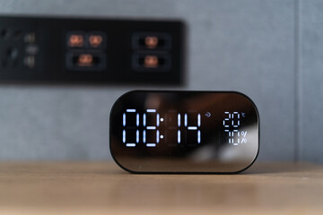 clock with digital display on side table 