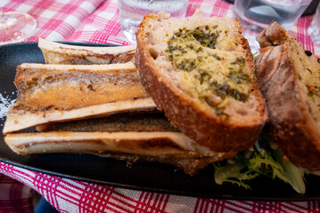 bone marrow served with toasted bred with herbs and sea salt in a traditional restaurant in france