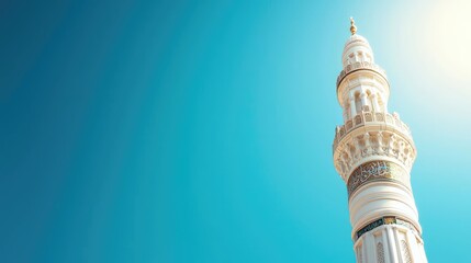 A stunning view of a mosque minaret against a clear blue sky, showcasing architectural beauty and serenity.