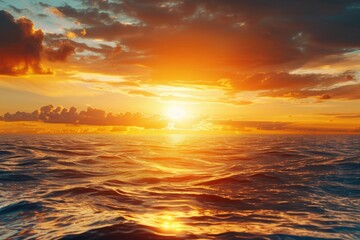 Fototapeta premium A serene moment of sunset over the ocean with a cloudy sky, perfect for use in travel or nature-related projects