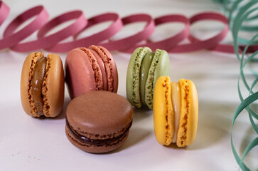 Close up of different pastel colored macaron cakes filled with cream. Culinary and cooking concept. Tasty colorful macarons