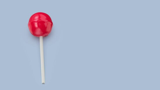 Red lollipop on a blue background