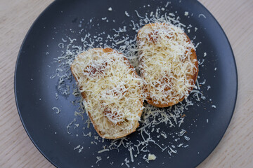 Toasted bread with cheese on top.