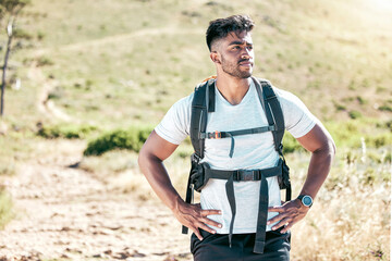 Fototapeta premium Thinking, hiker and man on mountain peak with nature, adventure and walking outdoors on exercise journey. Hiking, view or backpacking for workout with training, goal and achievement on running trail