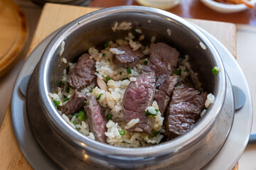 Rare beef rice in a steamed pot with butter. Korean food