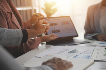 Close up of Business team analyzing income charts and graphs with modern laptop computer. Business analysis and strategy concept.