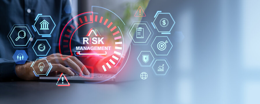 Businessman typing in laptop, risk management hologram with business icons