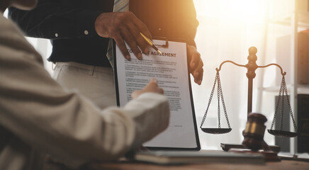 Judge gavel with Justice lawyers having team meeting at law firm background. Concepts of Law and...