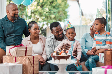 Birthday cake, gifts and black kid with family at party with balloons for celebration at home. Happy, presents and African girl with dessert for special event with grandparents, parents and brother