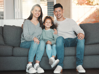 Happy, portrait and child with parents on sofa in home for bonding, security and family time....