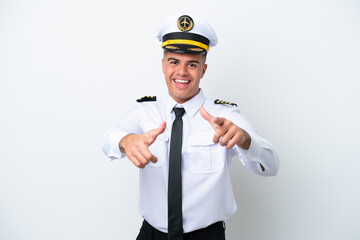 Airplane pilot caucasian man isolated on white background pointing to the front and smiling © luismolinero
