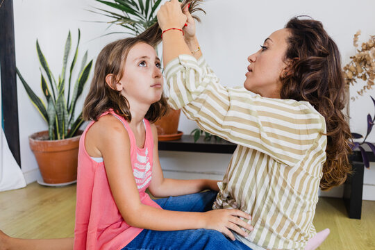 Head lices : mother examining nits to kid at home