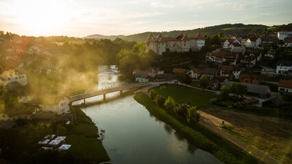 Fototapeta premium Zuzemberk Castle and medieval village on the river Krka in Slovenia. Aerial drone view