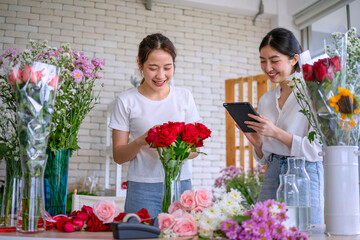 Young entrepreneurs are working at florist shop.