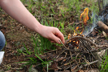 Man kindle a fire in the forest.