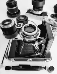 Old camera and lenses on white background. Black and white photo.
