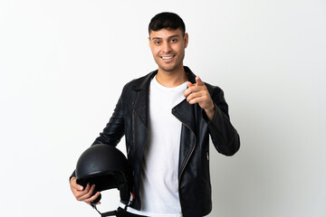 Man with a motorcycle helmet isolated on white background surprised and pointing front