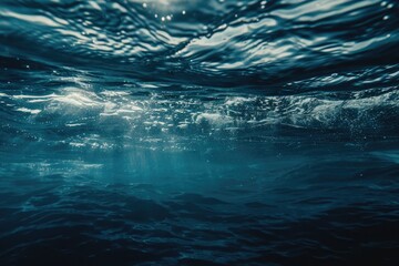 A serene blue ocean scene with sunlight shining through the water, perfect for use in travel or nature-related projects