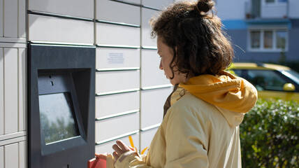 A Young Woman is Utilizing a Digital Locker Set within an Urban Environment Space