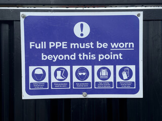 Construction site health and safety sign on fence