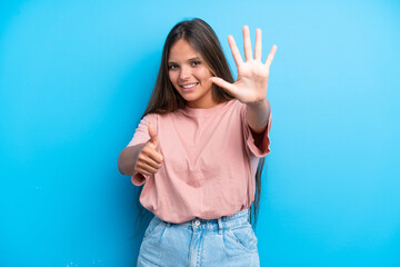 Young caucasian woman isolated on blue background counting six with fingers