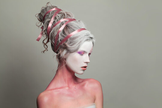 Female head and profile with makeup and creative hairstyle, beautiful face close-up. Carnival, Halloween or theater actress costume