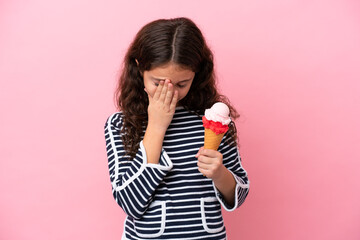 Little caucasian girl holding an ice cream isolated on pink background with tired and sick expression