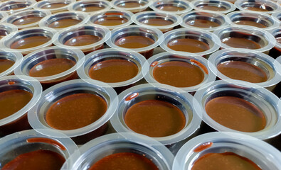 Close Up View Of Chocolate Pudding, A Sweet Treat Served In A Pudding Cup And Neatly Arranged
