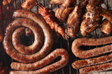 Boerewors, kebabs and lamb chops on a braai. sausages on a grill