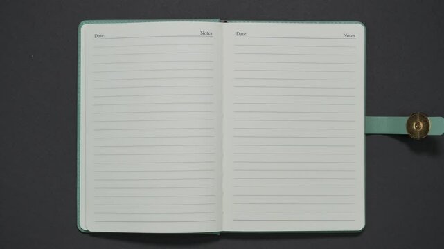 Stylish diary opens on blank page with word 'notes'. Stop motion animation
