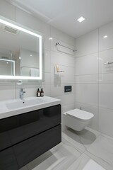 A photo of the modern bathroom in an apartment, white walls with light gray tiles on floor and wall, one black cabinet under sink, toilet is integrated into flooring, 